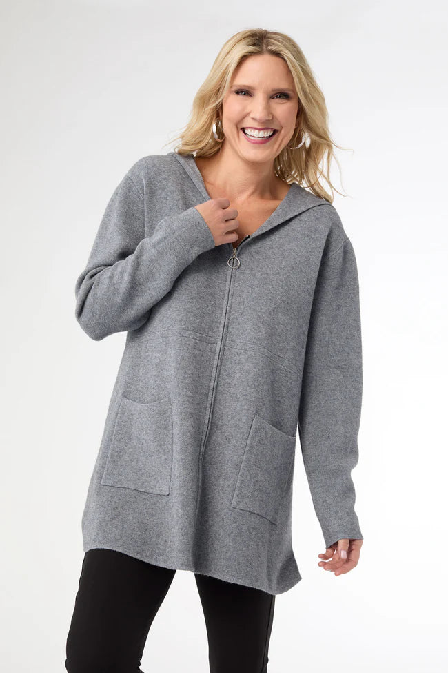 Woman wearing a gray zip-up hoodie on a white background