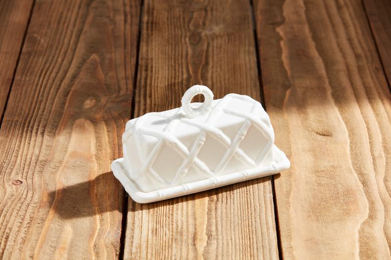 White ceramic butter dish on a wooden surface