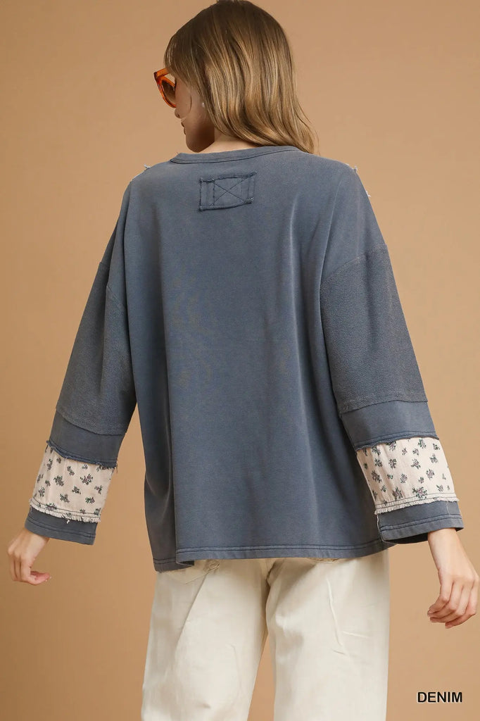 Close-up of floral and paisley patchwork details on sleeve of French Terry Pullover