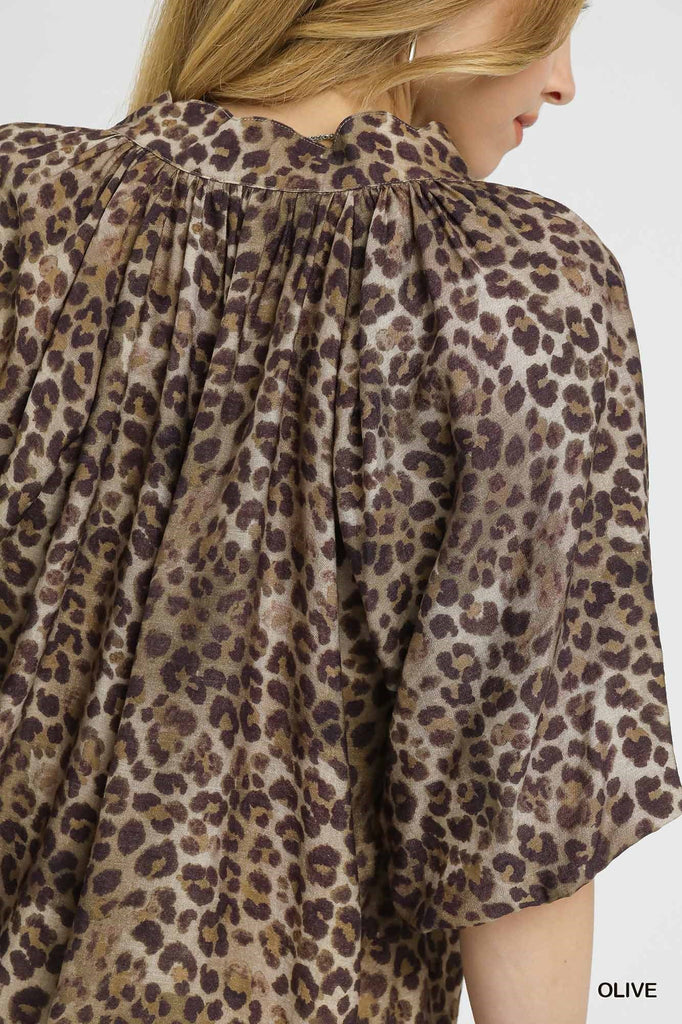 Leopard print olive top with V-neckline and scalloped hemline

