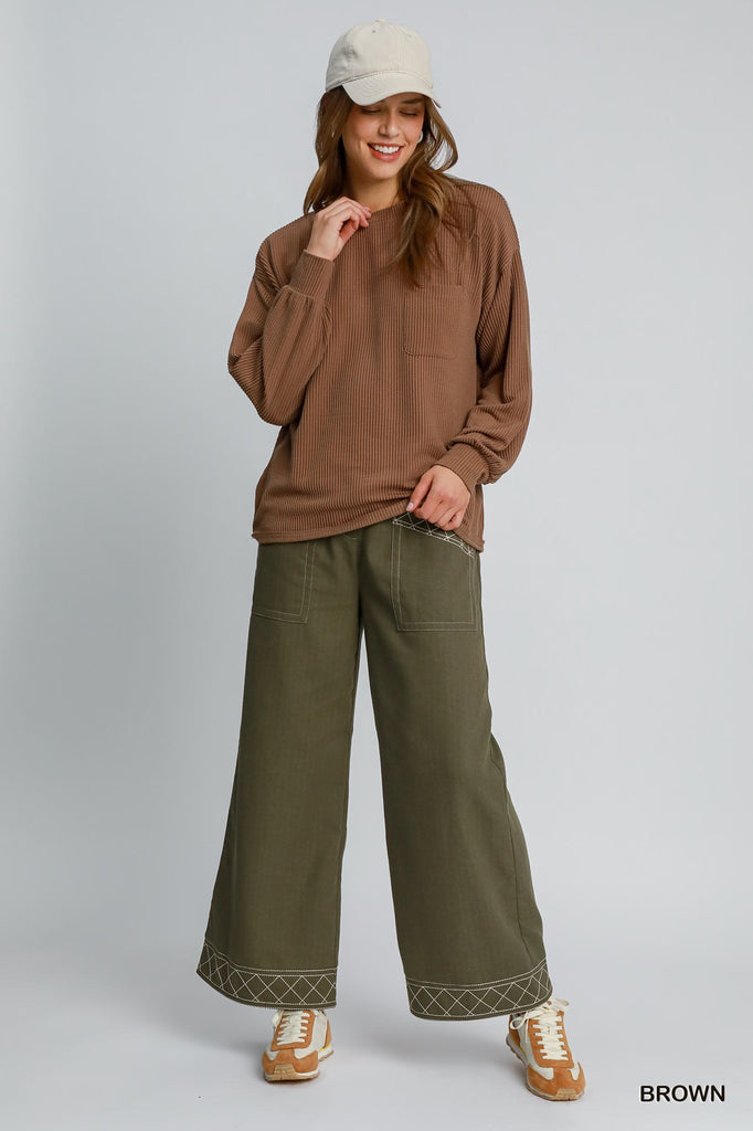 Casual brown knit top with front pocket and poly-rayon-spandex blend

