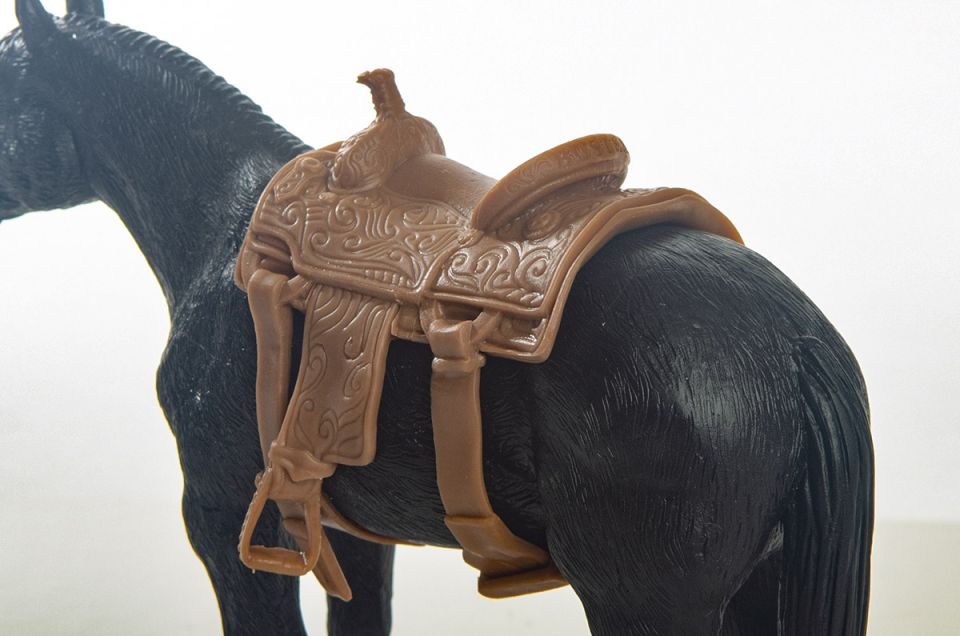 Little Buster Toys calf roping saddle with realistic tooling and stirrup details