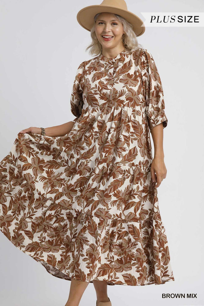 Woman wearing a brown and white floral dress with a beige hat on a white background