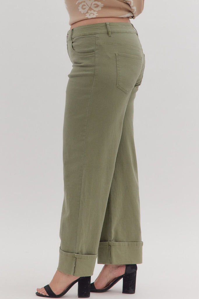 Green pants worn by a person on a white background