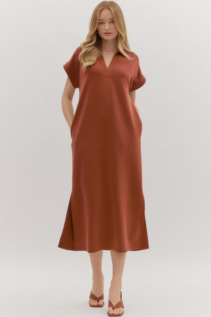 Woman wearing a rust-colored dress on a white background