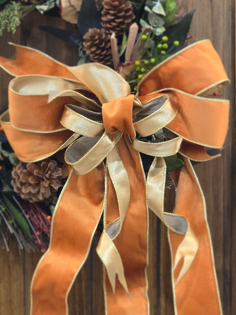 Close-up of a decorative bow with ribbons on a wooden surface